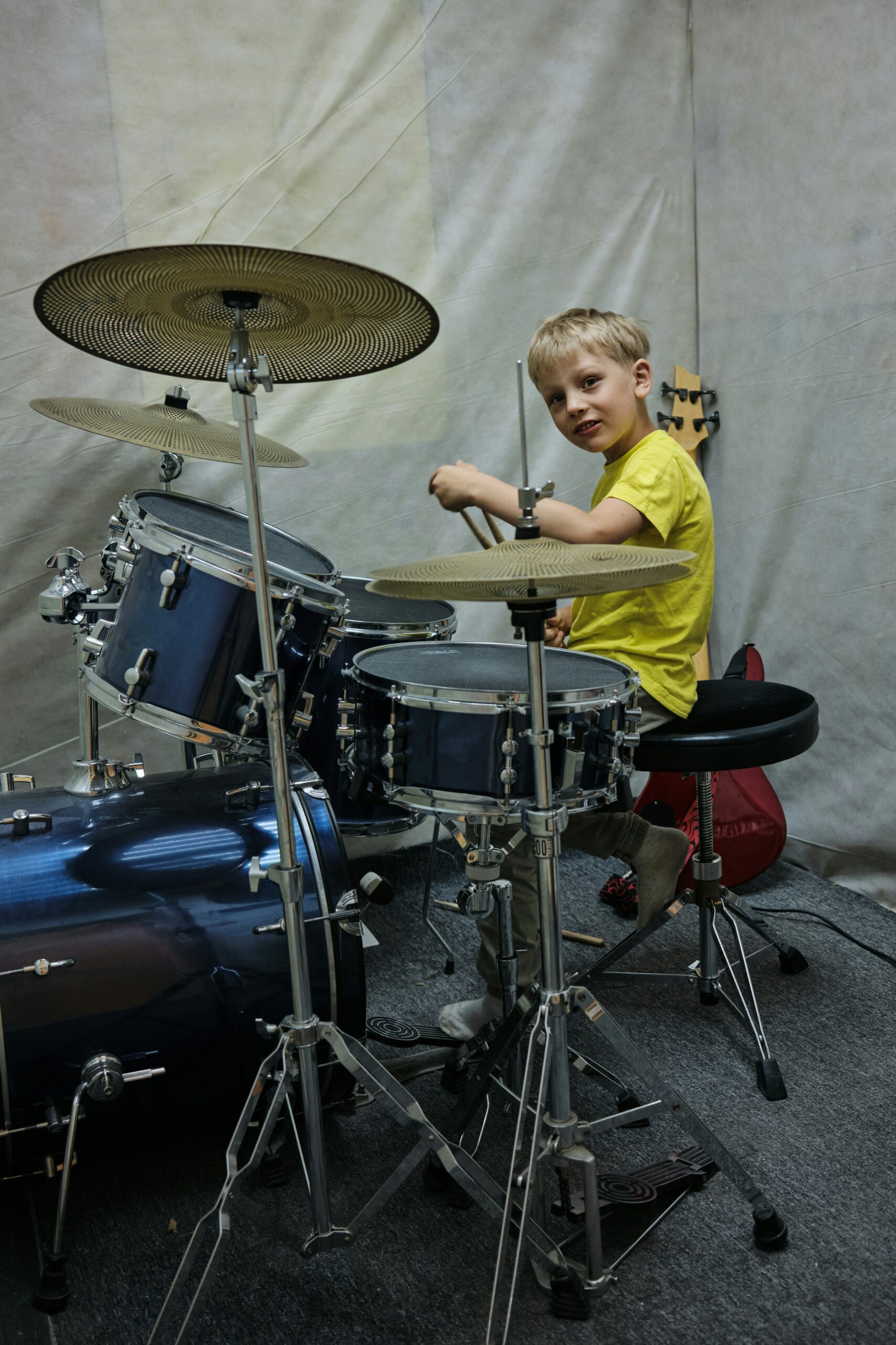 Beginner drummer sitting behind kit